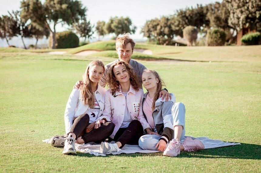 Ангелина с отцом, матерью и сестрой расположились посреди поля для гольфа на коврике - https://www.instagram.com/angelina_k21